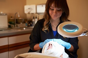 woman putting dressing on patient after dermabrasion