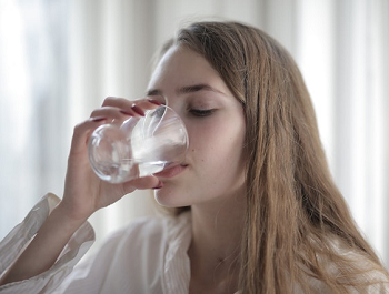 woman drinking a glass of water