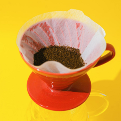 coffee grounds in an orange cup