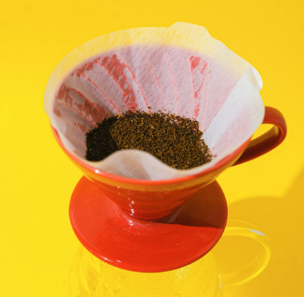 coffee grounds in an orange cup