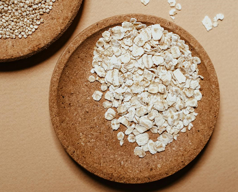 uncooked oats in wooden bowl