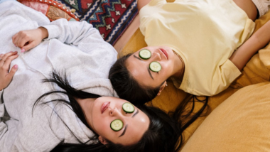 two women with cucumber slices on their eyes