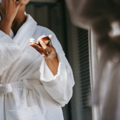 woman applying natural skincare product to her face