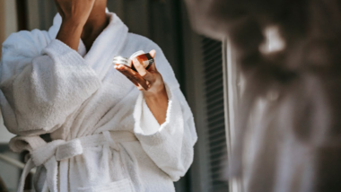 woman applying natural skincare product to her face