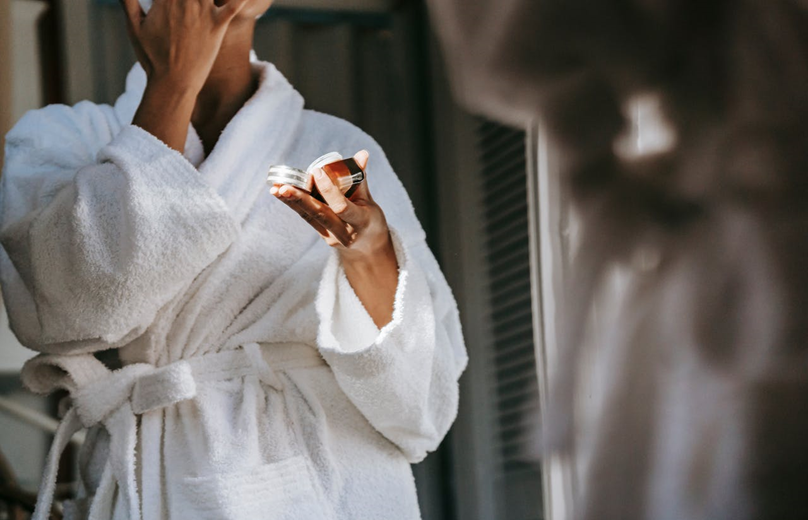 woman applying natural skincare product to her face