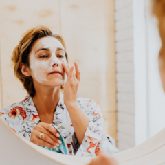 woman applying a skincare product to her face