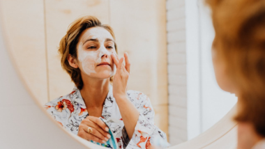 woman applying a skincare product to her face