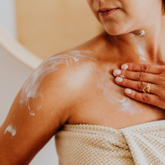 woman putting moisturizer on her skin