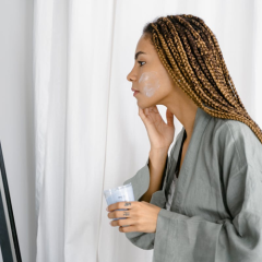 woman applying moisturizer to her face