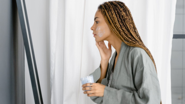 woman applying moisturizer to her face