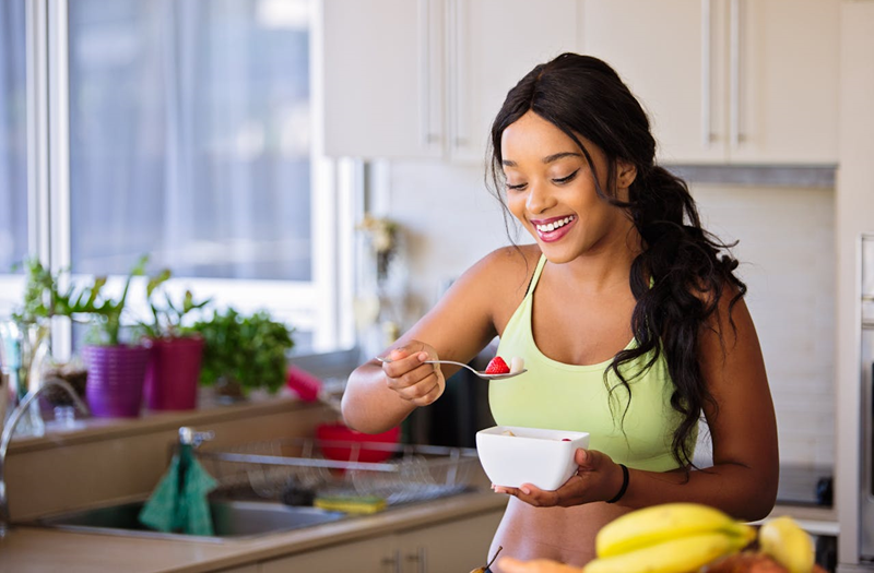 woman eating healthy food that is good for her skin