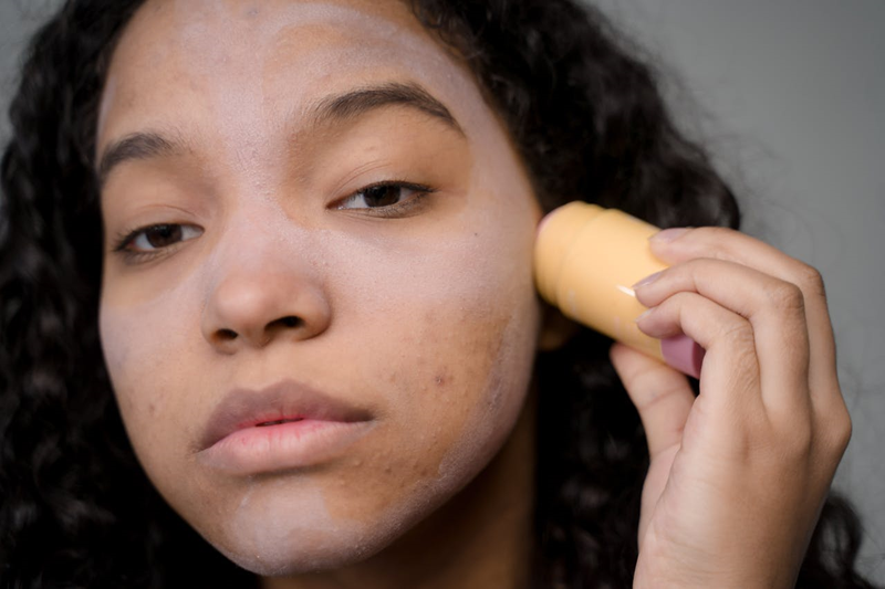 woman applying an acne skincare product to her face
